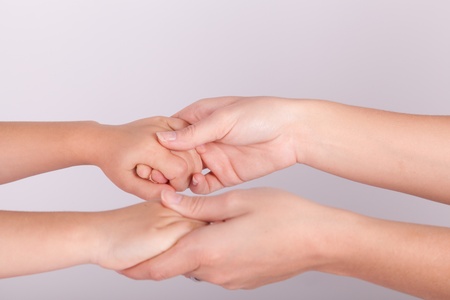 Mother and daughter are holding handsの写真素材