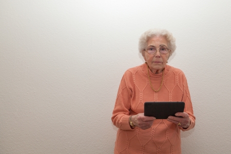An old woman with a tablet computerの写真素材