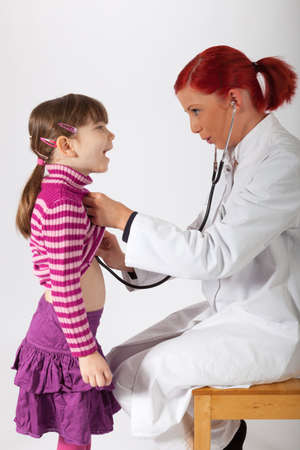 The young pediatrician listens on a little girlの写真素材