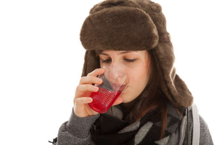 The young girl is drinking a glass of medicineの写真素材