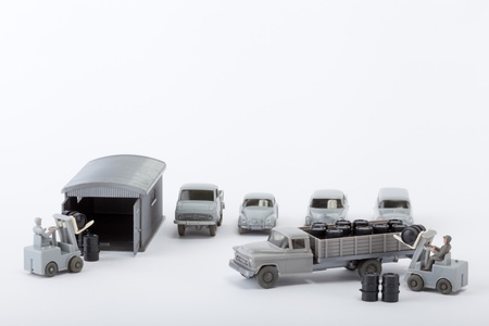 Barrels are unloaded from a truckの写真素材