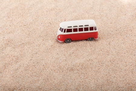 The little bus is standing at the beach