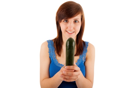 The young woman has a zucchini in her handsの写真素材