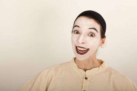 The clown is standing in front of a camera and making a faceの写真素材