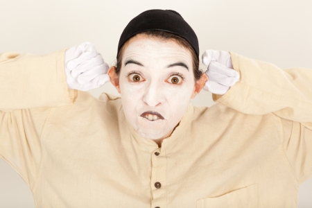 The clown is standing in front of a camera and making a faceの写真素材