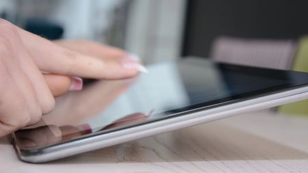 A girl using tablet, close up view.の写真素材