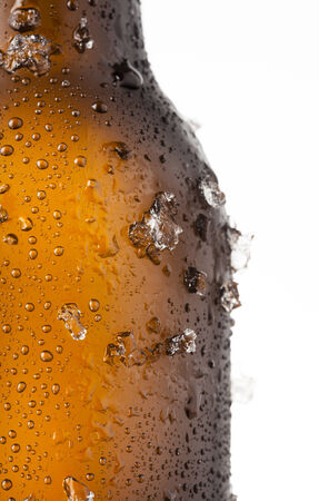 Bottle of ice cold beer with ice and dropsの写真素材