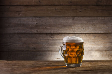 Beer on a wooden background with copyspaceの写真素材