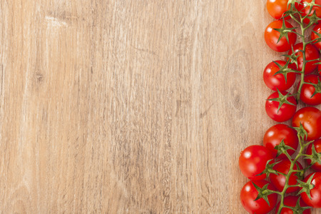 Red tomatoes on wooden boardの写真素材
