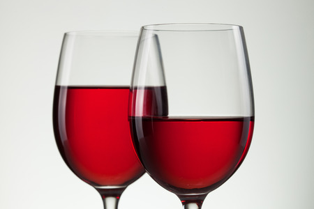 Glass of wine and bottle on white with copy space