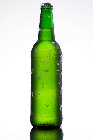 Bottle of ice cold beer with ice and dropsの写真素材