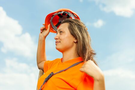Happy woman unloading shed with coalの写真素材
