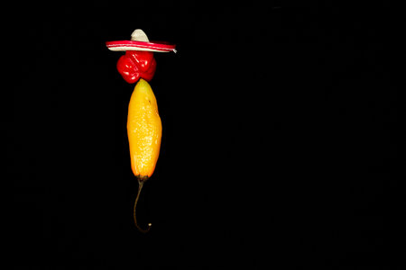 Vegetable chilli, chile face on black backgroung