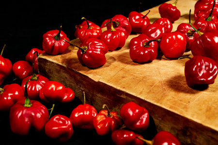 chilli, chile habanero tout on a cut table and black backgroundの写真素材