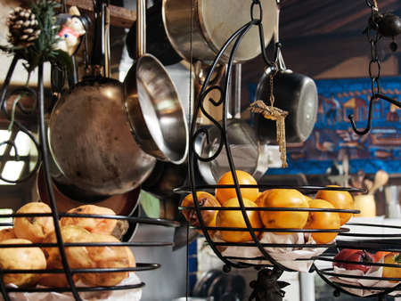 hanging kitchen utensils, fruits, pots, pans, vintageの写真素材