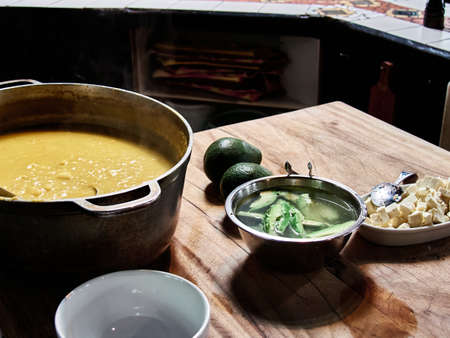 Traditional ecuadorian locro soup with cheese and avocadoの写真素材