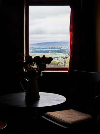 Window opened in a rustic old house. Backlight with outdoor viewの写真素材