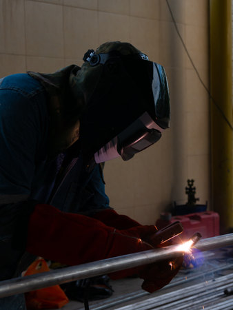 Iron soldering, Man working on iron soldering, welding sparks