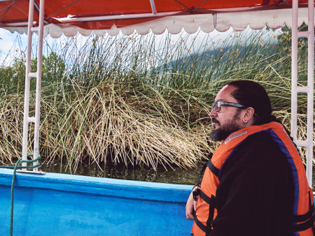 Enjoying a Peaceful Day on the Lake: Man in a Life Vestの写真素材