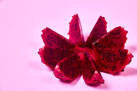 Red dragon fruit Set with appetizing serving Isolated on pink background. Top view, handの写真素材