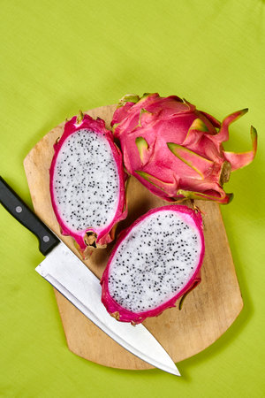 Red dragon fruit Set with appetizing serving Isolated on reen background. Top view, hand knife tableの写真素材