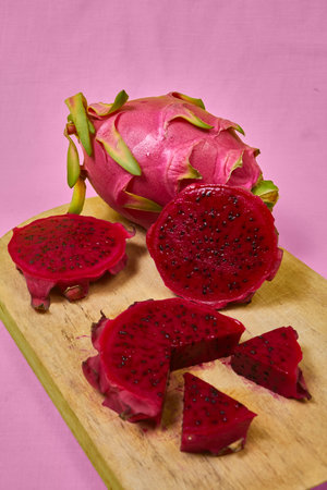 Red dragon fruit Set with appetizing serving Isolated on pink background. Top view, handの写真素材