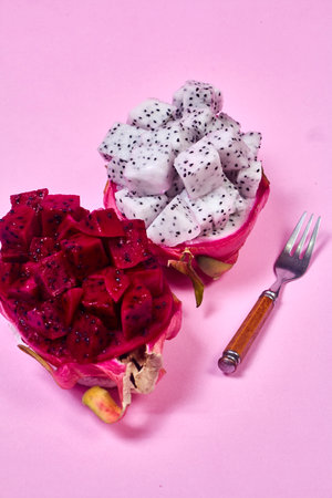 Red dragon fruit Set with appetizing serving Isolated on pink background. Top view, handの写真素材