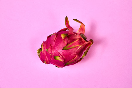 Red dragon fruit Set with appetizing serving Isolated on pink background. Top view, handの写真素材