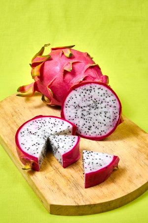 Red dragon fruit Set with appetizing serving Isolated on reen background. Top view, hand knife tableの写真素材