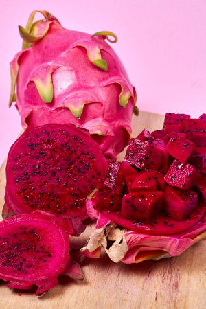 Red dragon fruit Set with appetizing serving Isolated on pink background. Top view, handの写真素材