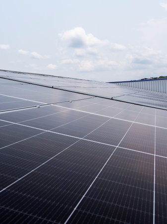 Solar panels installed on industrial warehouse roof generating renewable energy