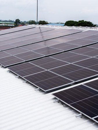 Solar panels installed on industrial warehouse roof generating renewable energy
