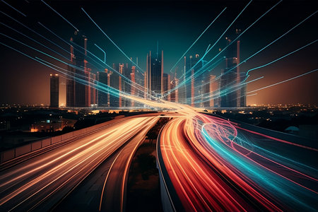 Highway in the city at night, light trails on the road. A cityscape with lights on and a cityscape in the backgroundの素材