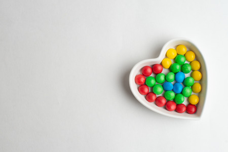 A bowl of multicolor chocolate candiesの写真素材