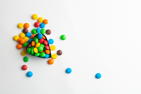 A bowl of multicolor chocolate candiesの写真素材