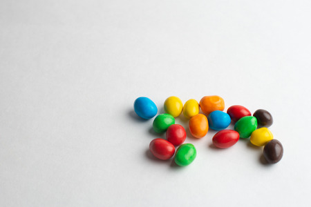 Colorful chocolate candies on the white background