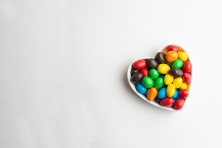 Coated chocolate candies shaped into a heartの写真素材
