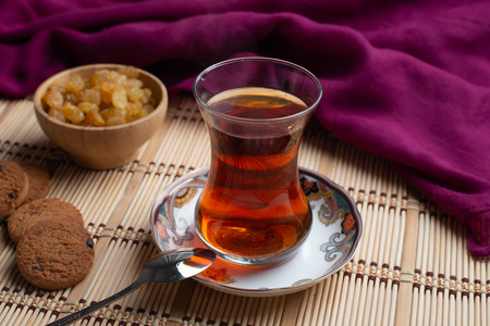 Homemade oatmeal cookies with a cup of tea on old wooden background, A cup of tea with raisin, a cup of tea with chocolateの写真素材