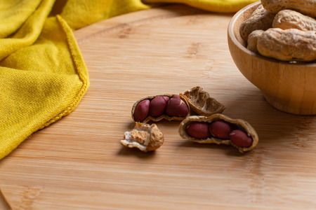 Walnuts kernels on dark desk with color background, Whole walnut in wood vintage bowl, Nuts in...