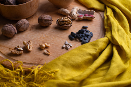 Walnuts kernels on dark desk with color background, Whole walnut in wood vintage bowl, Nuts in bamboo wooden bowl, walnuts in wood bamboo bowlの写真素材