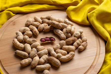Walnuts kernels on dark desk with color background, Whole walnut in wood vintage bowl, Nuts in...
