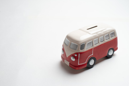 Red bus moneybox with coins.の写真素材