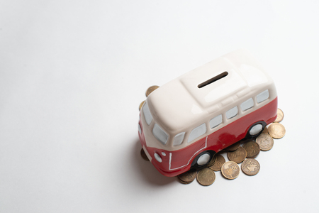 Red bus moneybox with coins.の写真素材