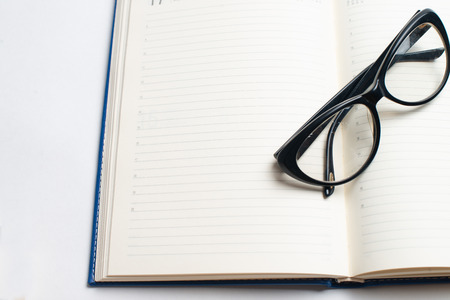 Notebook with glasses and pen, Book with glasses, Blue notebook with glasses, Book with cup of tea, working with glasses and pen, write to notebookの写真素材