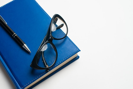 Notebook with glasses and pen, Book with glasses, Blue notebook with glasses, Book with cup of tea, working with glasses and pen, write to notebookの写真素材