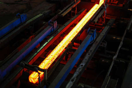 Red hot steel metal billets after molten steel casting.  Continuous casting machine. Background of the blacksmith and metallurgical industry.の写真素材