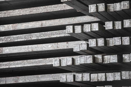 Steel billets in the warehouse of metallurgical factory. Hot ingot in a steel plant.の写真素材