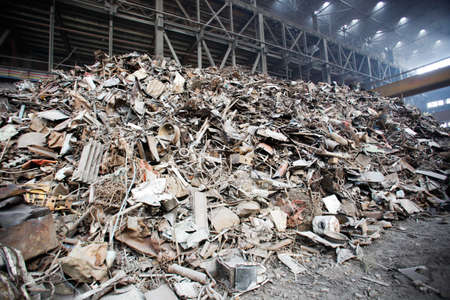 Metal scrap over rusty iron waste at junk yard. Iron raw materials ready for recycling.の写真素材