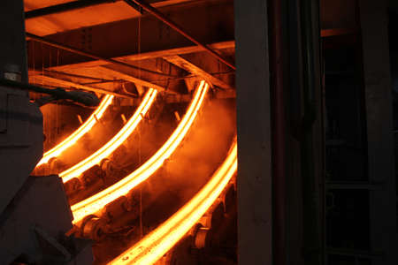 Red hot steel metal billets after molten steel casting.  Continuous casting machine. Background of the blacksmith and metallurgical industry.の写真素材