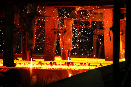 Steel billets at torch cutting in metallurgical plant. Metallurgical production, heavy industry,...